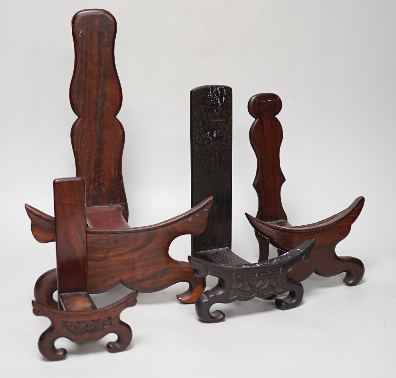 Four Chinese hardwood wood plate or dish stands, tallest 33cm